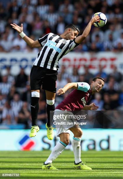 Ayoze Perez of Newcastle United and Mark Noble of West Ham United battle for possession in the air during the Premier League match between Newcastle...