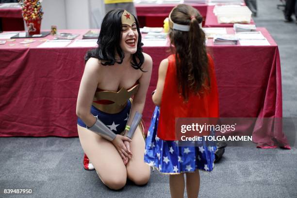 Two cosplayers dressed as Wonder Woman attend London Super Comic Convention at Business Design Centre in Islington, London on August 26, 2017.