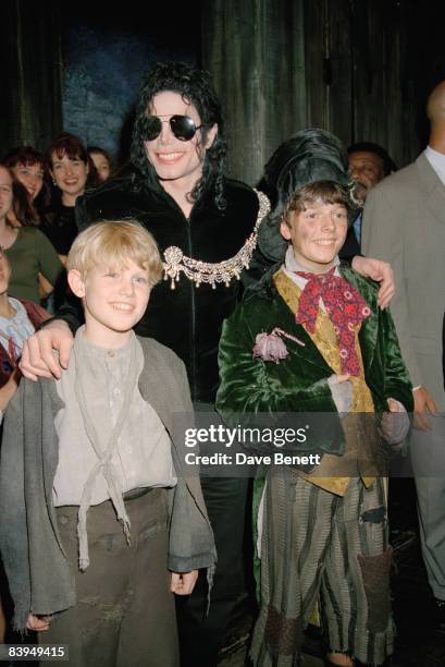 American singer Michael Jackson with cast members at a performance of the musical 'Oliver' at the Palladium Theatre, London, 4th October 1996.