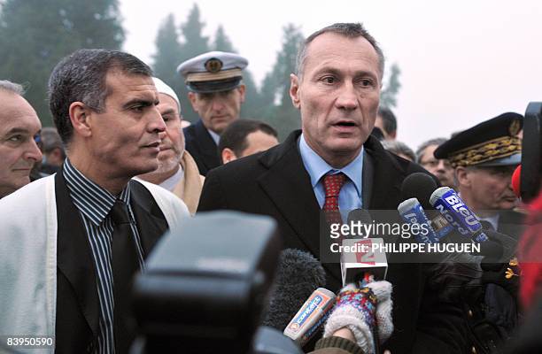 French junior defence minister Jean-Marie Bockel answers to journalists' questions near representatives of the Islamic community on December 8, 2008...