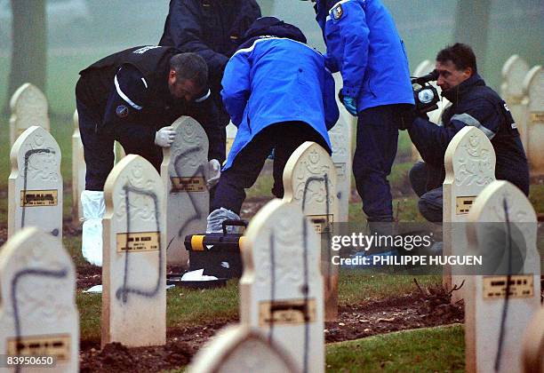 French gendarme look for clues on December 8, 2008 at Notre-Dame-de-Lorette cemetery in Ablain-Saint-Nazaire near the northern town of Arras, after...