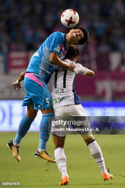 Kim Min Hyeok of Sagan Tosu and Hwang Ui Jo of Gamba Osaka compete for the ball during the J.League J1 match between Sagan Tosu and Gamba Osaka at...
