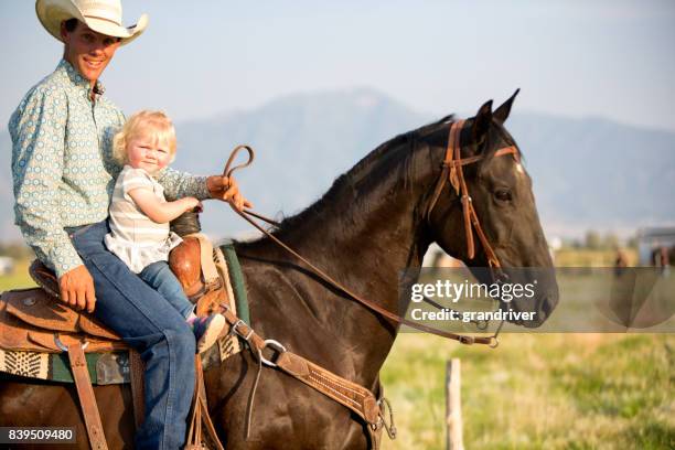 cowboy-vater und zwei jahre altes mädchen - 2 year old blonde girl father stock-fotos und bilder