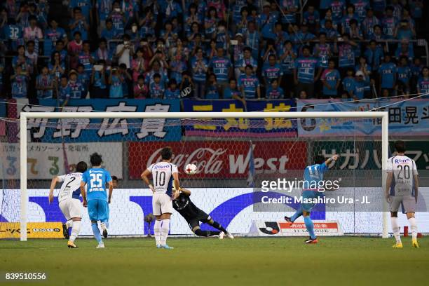 Yohei Toyoda of Sagan Tosu converts the penalty to score his side's first goal past Masaaki Higashiguchi of Gamba Osaka during the J.League J1 match...