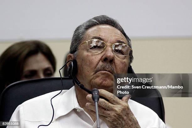 President Raul Castro of Cuba adjusts his headphones during the opening session of the third CARICOM summit, a trade organization of 14 Caribbean...