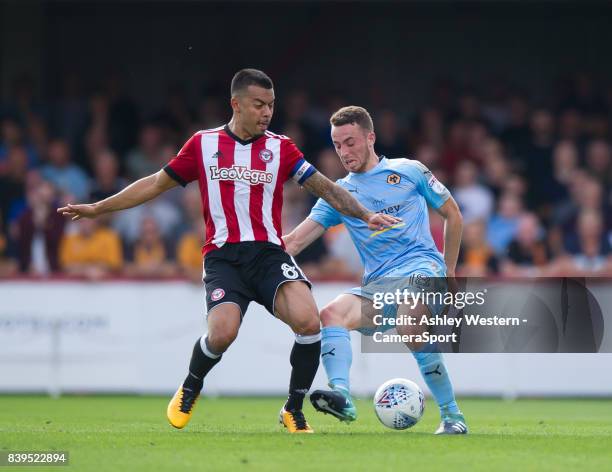 Brentford's Nico Yennaris battles for possession with Wolverhampton Wanderers' Diogo Jota during the Sky Bet Championship match between Brentford and...