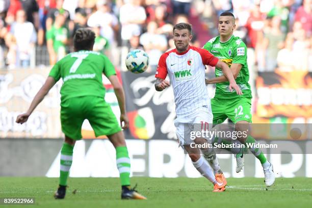 Patrick Herrmann of Moenchengladbach , Daniel Baier of Augsburg and Laszlo Benes of Moenchengladbach during the Bundesliga match between FC Augsburg...