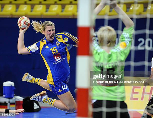 Sweden's Johanna Ahlm shoots at goal defended by Germany's goalkeeper Clara Woltering during the 8th Women's Handball European Championships match on...