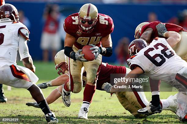 Linebacker Mark Herzlich of the Boston College Eagles picks up a fumble against the Virginia Tech Hokies in the 2008 ACC Football Championship game...