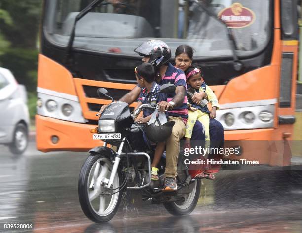 Commuters caught during heavy rain, on August 26, 2017 in New Delhi, India. The rains brought much respite to the residents from the prevailing warm...