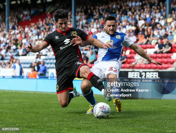 Blackburn Rovers' Craig Conway competing with Milton Keynes Dons' George Williams during the Sky Bet League One match between Blackburn Rovers and...