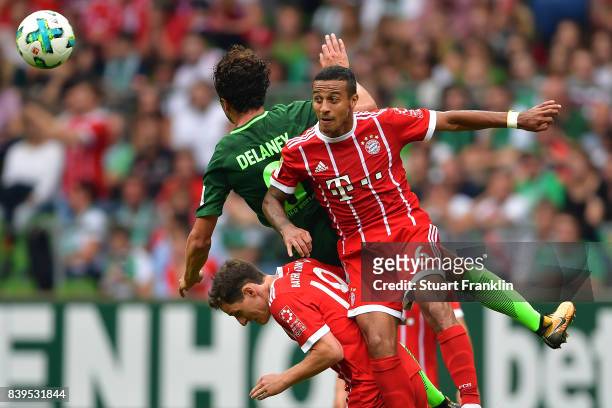 Thiago Alcantara of Bayern Muenchen fights for the ball with Thomas Delaney of Bremen and Sebastian Rudy of Bayern Muenchen during the Bundesliga...