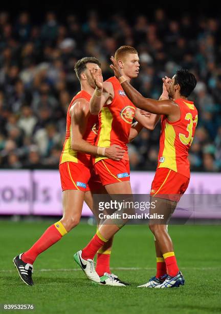Peter Wright of the Suns celebrates after kicking a goal during the round 23 AFL match between the Port Adelaide Power and the Gold Coast Suns at...