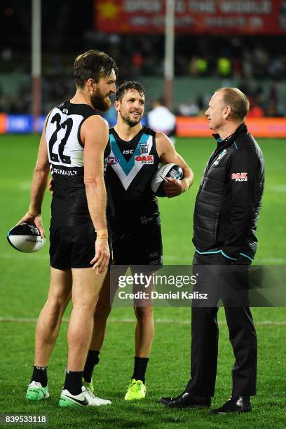 Charlie Dixon and Travis Boak of the Power chat with Ken Hinkley the coach of the Power after the round 23 AFL match between the Port Adelaide Power...