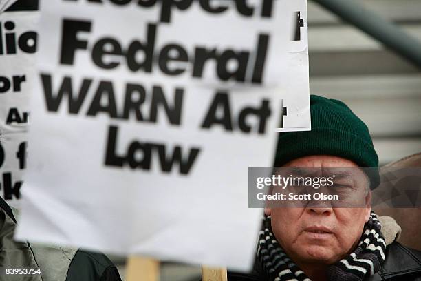Worker holds a picket outside the Republic Windows and Doors factory December 8, 2008 in Chicago, Illinois. About 200 other workers, who got three...