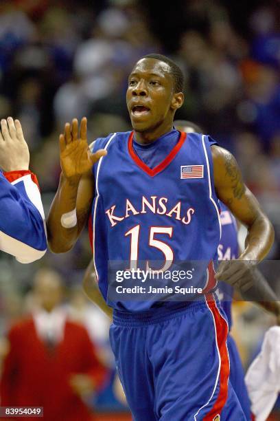 Tyshawn Taylor of the Kansas Jayhawks celebrates on the court against the Washington Huskies during the CBE Classic game at the Sprint Center in...