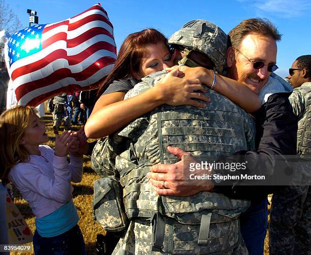 Alexandria McBroom, left, hugs her husband U.S. Army PFC Dustin McBroom during a homecoming ceremony for 200 soldiers with the Army's 3rd Infantry...