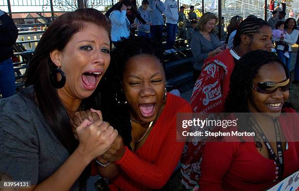 Alexandria McBroom and her friend Stephanie Brooks scream for their husbands during a homecoming ceremony for 200 troops with the U.S. Army 3rd...