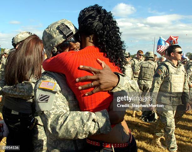 Army Sgt. Jatorrio Brooks hugs his wife Stephanie Brooks during a homecoming ceremony for 200 troops with the 3rd Infantry Division's 4th Brigade...