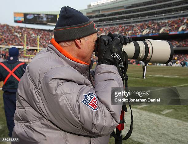 Michael McCaskey, Chariman of the Board of the Chicago Bears, tries his hand at sideline photography during a game between the Bears and the...