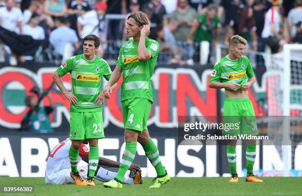 Jonas Hofmann of Moenchengladbach , Jannik Vestergaard of Moenchengladbach and Nico Elvedi of Moenchengladbach dejected after the Bundesliga match...