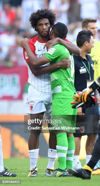 Raffael of Moenchengladbach and Caiuby of Augsburg embrace after the Bundesliga match between FC Augsburg and Borussia Moenchengladbach at WWK-Arena...