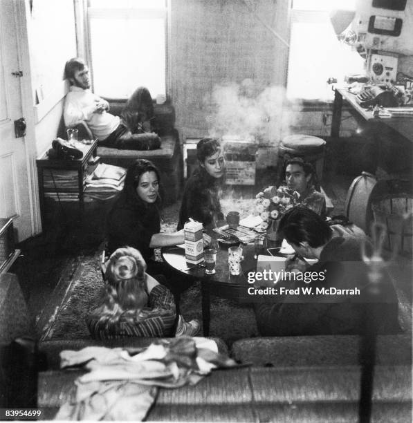 Group of beatniks sit in an apartment , New York, New York, December 5, 1959. Pictured, foreground from left, Dian Doyle and Kirby Doyle ; far side...