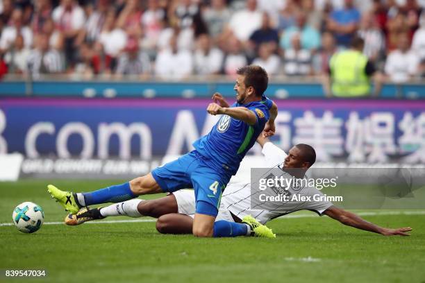 Sebastian Haller of Frankfurt is challenged by Ignacio Camacho of Wolfsburg during the Bundesliga match between Eintracht Frankfurt and VfL Wolfsburg...