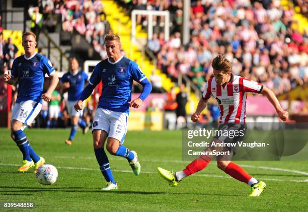 Lincoln City's Alex Woodyard scores his sides second goal during the Sky Bet League Two match between Lincoln City and Carlisle United at Sincil Bank...