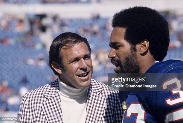 Former quarterback John Brodie interviews runningback O.J. Simpson of the Buffalo Bills prior to a game October 5, 1975 against the Denver Broncos at...