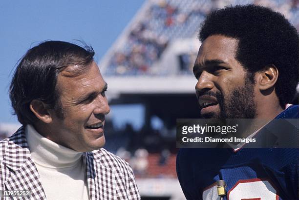 Former quarterback John Brodie interviews runningback O.J. Simpson of the Buffalo Bills prior to a game October 5, 1975 against the Denver Broncos at...