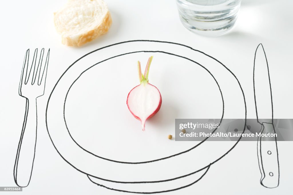 Half a radish and two peppercorns on plate, bread nearby