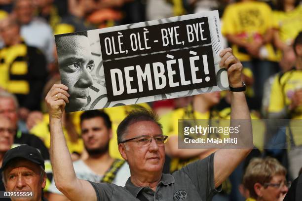 Fan holds up a sign in response to Dortmund's Ousmane Dembele's departure ahead of the Bundesliga match between Borussia Dortmund and Hertha BSC at...
