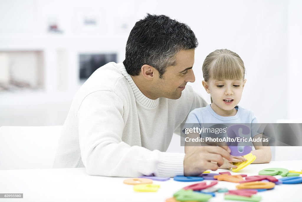 Father and young daughter learning numbers together