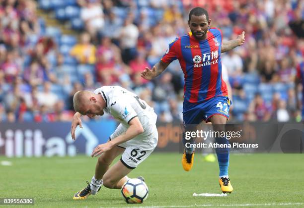 Oliver McBurnie of Swansea City is tackled by Jason Puncheon of Crystal Palace during the Premier League match between Crystal Palace and Swansea...