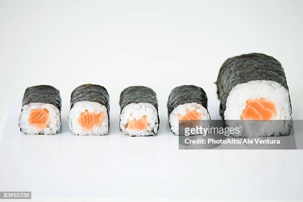 five pieces of maki sushi arranged in row, end piece larger than others - maki sushi ストックフォトと画像
