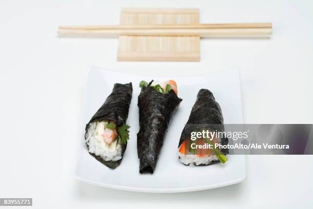 temaki sushi on sushi plate with chopsticks - hand roll stock pictures, royalty-free photos & images