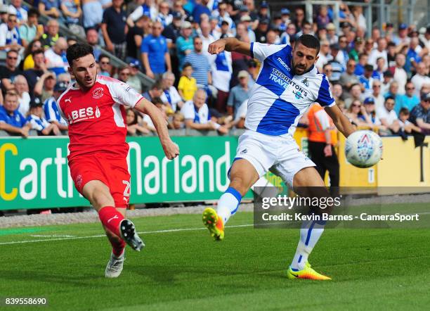 Fleetwood Town's Lewis Coyle crosses despite the attentions of Bristol Rovers' Liam Sercombe during the Sky Bet League One match between Bristol...