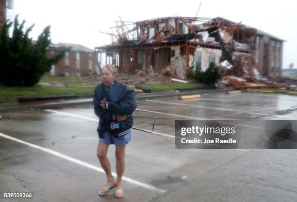 Jacque McKay walks through the apartment complex where she lives and road out the storm after Hurricane Harvey destroyed many of the apartments on...