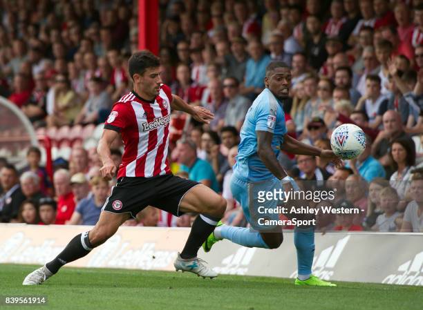 Brentford's Maxime Colin battles for possession with Wolverhampton Wanderers' Ivan Cavaleiro during the Sky Bet Championship match between Brentford...