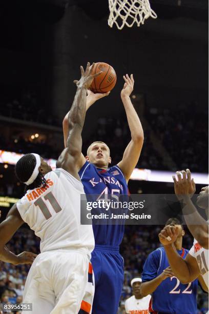 Cole Aldrich of the Kansas Jayhawks puts a shot up against Paul Harris of the Syracuse Orange during the CBE Classic championship game on November...