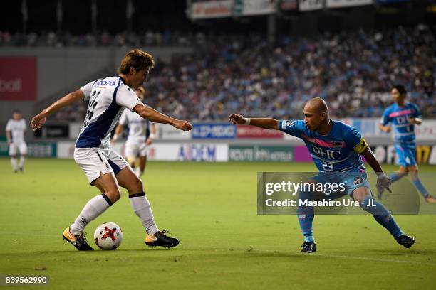 Koki Yonekura of Gamba Osaka takes on Yutaka Yoshida of Sagan Tosu during the J.League J1 match between Sagan Tosu and Gamba Osaka at Best Amenity...