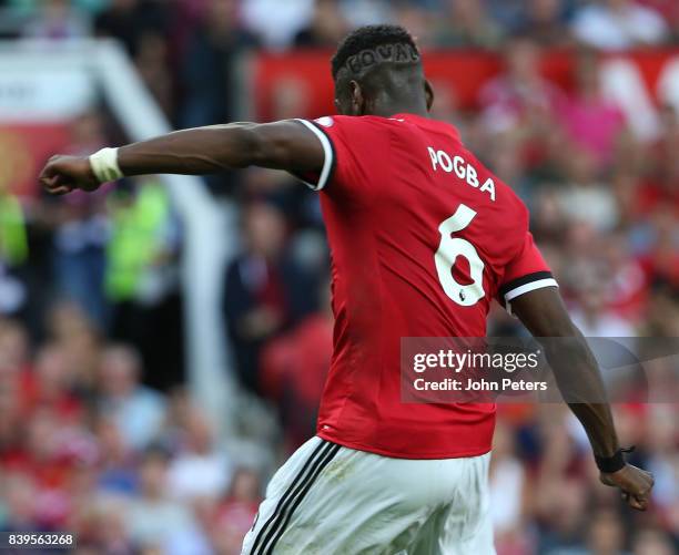 Paul Pogba of Manchester United shows off a hairstyle with Equal shaved into his head during the Premier League match between Manchester United and...