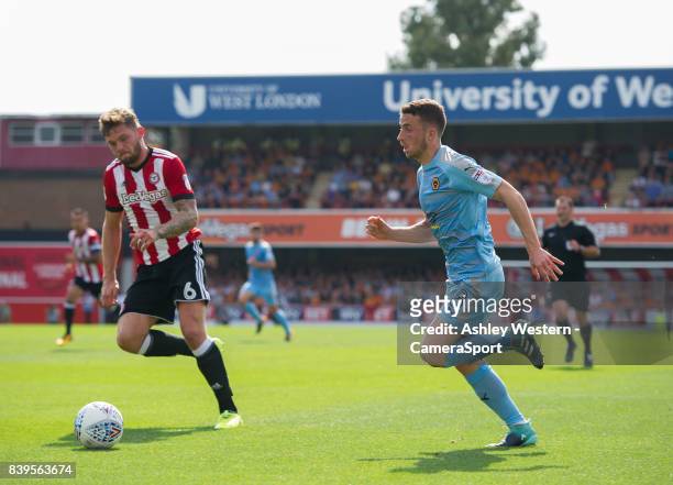 Wolverhampton Wanderers' Diogo Jota holds off the challenge from Brentford's Harlee Dean during the Sky Bet Championship match between Brentford and...