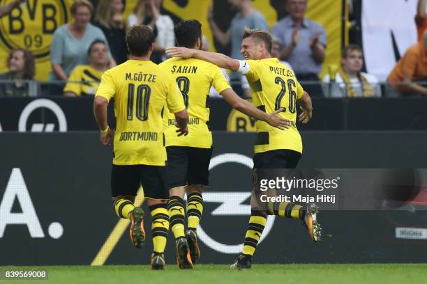 Nuri Sahin of Dortmund is congratulated by Mario Goetze of Dortmund and Lukasz Piszczek of Dortmund after he scored to make it 2:0 during the...