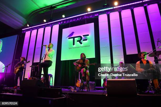 Bassist Ben McKee, singer Dan Reynolds, guitarist Wayne Sermon and drummer Daniel Platzman of Imagine Dragons perform at the Tyler Robinson...