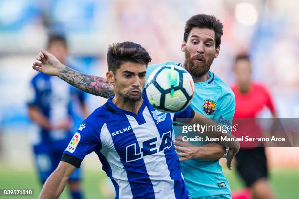 Lionel Messi of FC Barcelona duels for the ball with Enzo Zidane of Deportivo Alaves during the La Liga match between Deportivo Alaves and Barcelona...