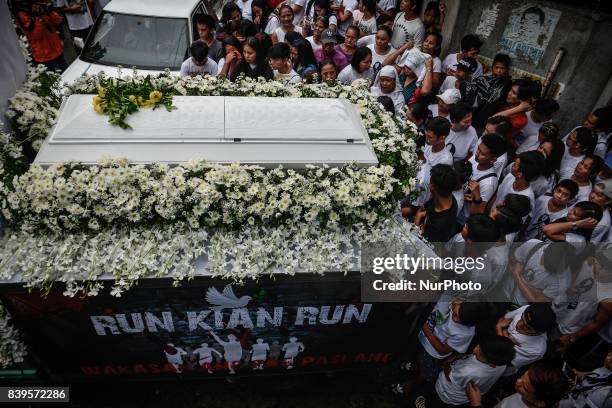 Relatives and friends take part in the funeral procession of Kian Loyd Delos Santos in Caloocan, Metro Manila, Philippines, August 26, 2017. Amidst...