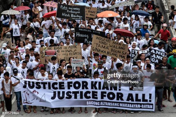 Residents and activists take part in a demonstration during the funeral procession of Kian Loyd Delos Santos in Caloocan, Metro Manila, Philippines,...