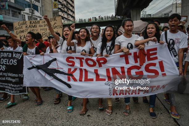 Residents and activists chant slogans during the funeral procession of Kian Loyd Delos Santos in Caloocan, Metro Manila, Philippines, August 26,...